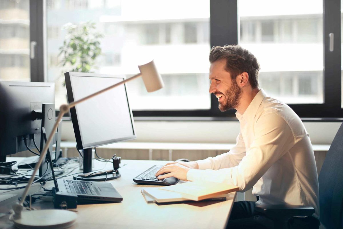 Male smiling while working at desk