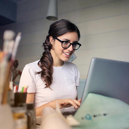 Female with glasses working on laptop